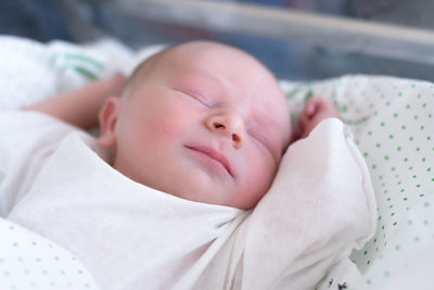 Cute baby sleeping on bed