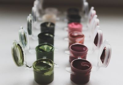 Close-up of watercolor paints in containers on table