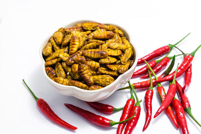 Close-up of red chili pepper against white background