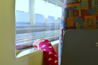 Close-up of person sitting in train