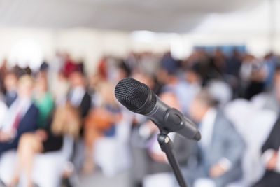 Close-up of microphone against audience