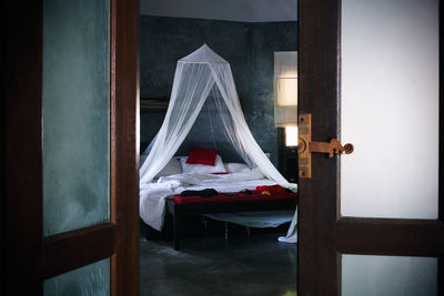 Bed with mosquito net in house