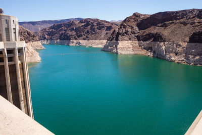 Scenic view of sea and mountains against blue sky