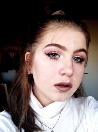 Close-up portrait of young woman at home