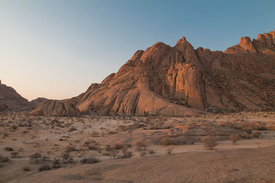 Panoramic view of arid landscape against clear sky