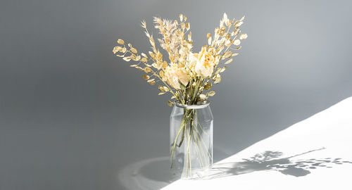 Withered flowers bouquet in plastic bottle to reduce waste. aesthetic and eco friendly home decor.