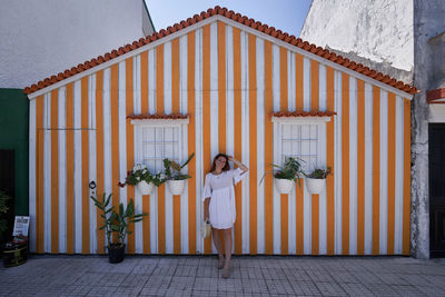 Woman standing outside building