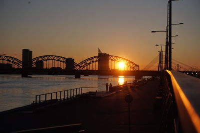 Bridge over river at sunset