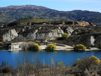 Scenic view of lake and mountains against sky