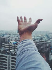 Cropped image of man's hand in city