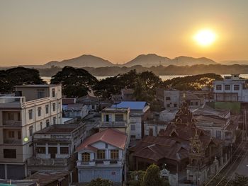 High angle shot of townscape against sky at sunset