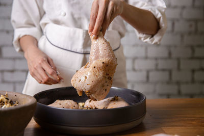 Midsection of woman preparing food on table