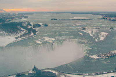 Aerial view of niagara falls against sky during sunset