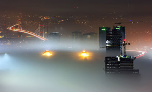 High angle view of incomplete skyscrapers in foggy weather with bosphorus bridge