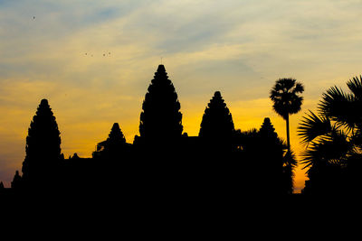 Low angle view of silhouette trees against sky at sunset