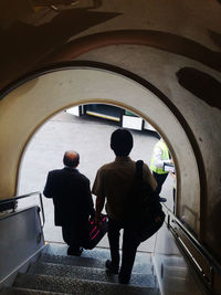 Rear view of man standing in tunnel