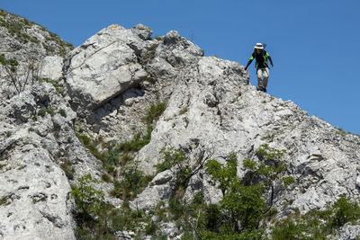 Low angle view of man walking on mountain
