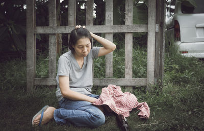 Full length of a girl sitting on land