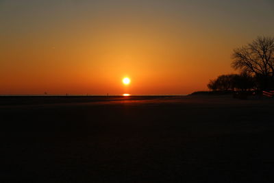 Scenic view of sea against orange sky