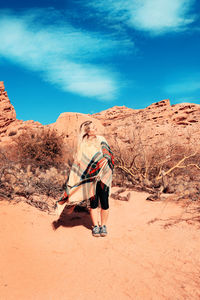 Full length of man skateboarding on land against sky