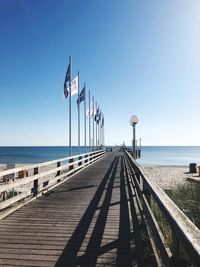 Pier over sea against clear sky