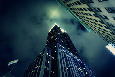 Low angle view of illuminated buildings against sky at night