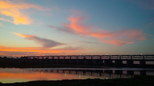 Scenic view of lake against orange sky