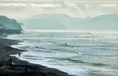 Scenic view of sea against sky in foggy morning