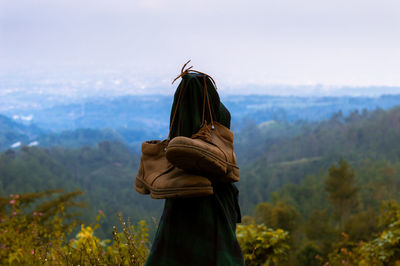 Rear view of person standing against sky