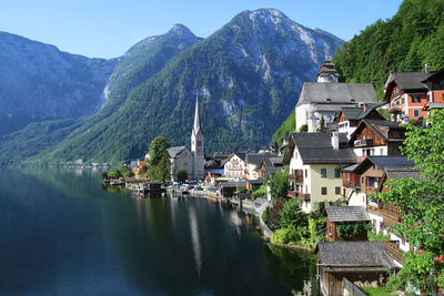 Panoramic view of townscape by mountain against sky