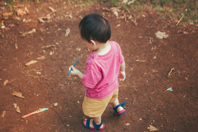 High angle view of cute girl standing on land