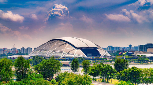 View of modern buildings against cloudy sky