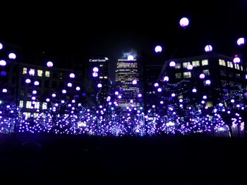 Low angle view of illuminated fireworks against sky at night