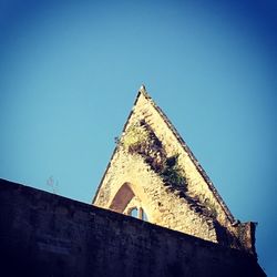 High section of built structure against clear blue sky