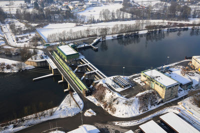 High angle view of dam and buildings in winter