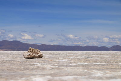 Rocks in sea against sky