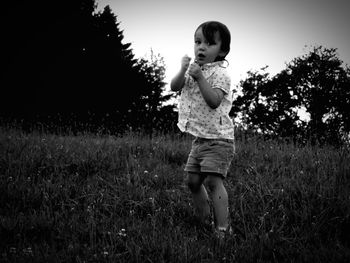 Full length of boy standing on grassy field