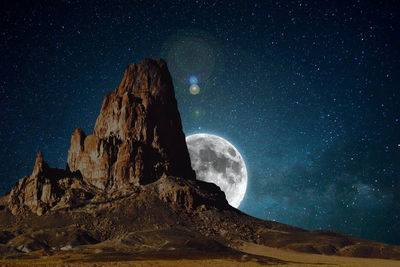 Scenic view of rock formation against sky at night