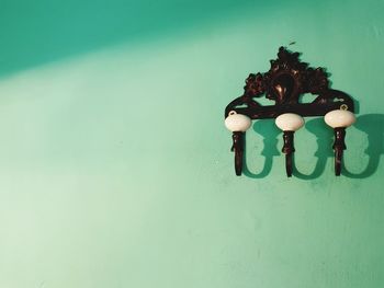 Close-up of lighting equipment on table against wall