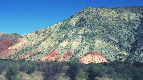 Scenic view of mountains against clear blue sky