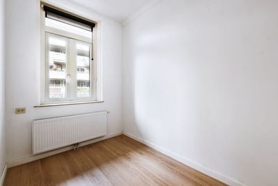 Empty white wall near window at home