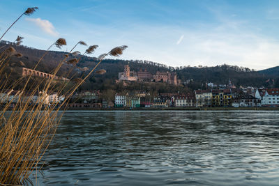 Scenic view of sea by town against sky
