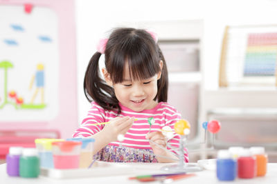 Cute girl playing with toy at home