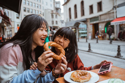 Side view of woman having food at restaurant