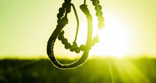 Close-up of decoration hanging against bright sky