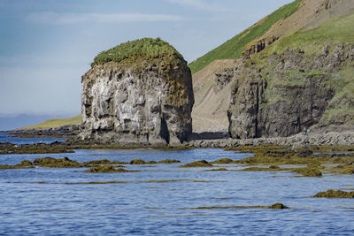 Rocks in sea against sky