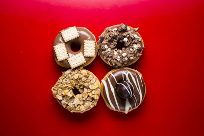 Directly above shot of cupcakes on red background