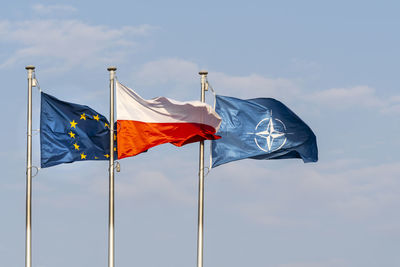 Low angle view of flags flag against sky