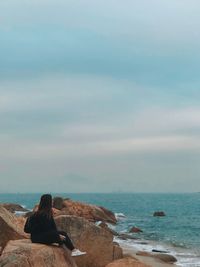 Man looking at sea against sky