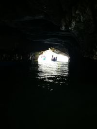 People in illuminated tunnel